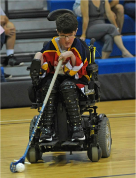 Luke Hoban, Forward and Defenseman for the Philadelphia Powerplay power hockey team, has been on the team almost as long as it has been around. Hoban is concentrating on the ball during a tournament game.