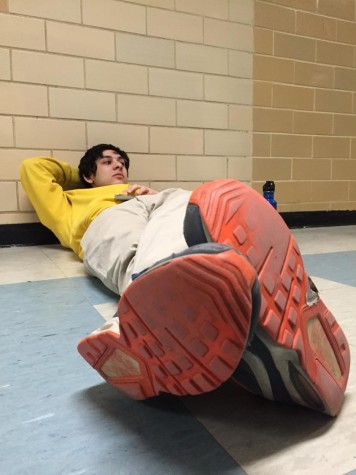 Junior Aaron Franklin relaxes by lying down backstage during one of his breaks. Franklin said it's good "to get away from it all" during his downtime to keep focused. 