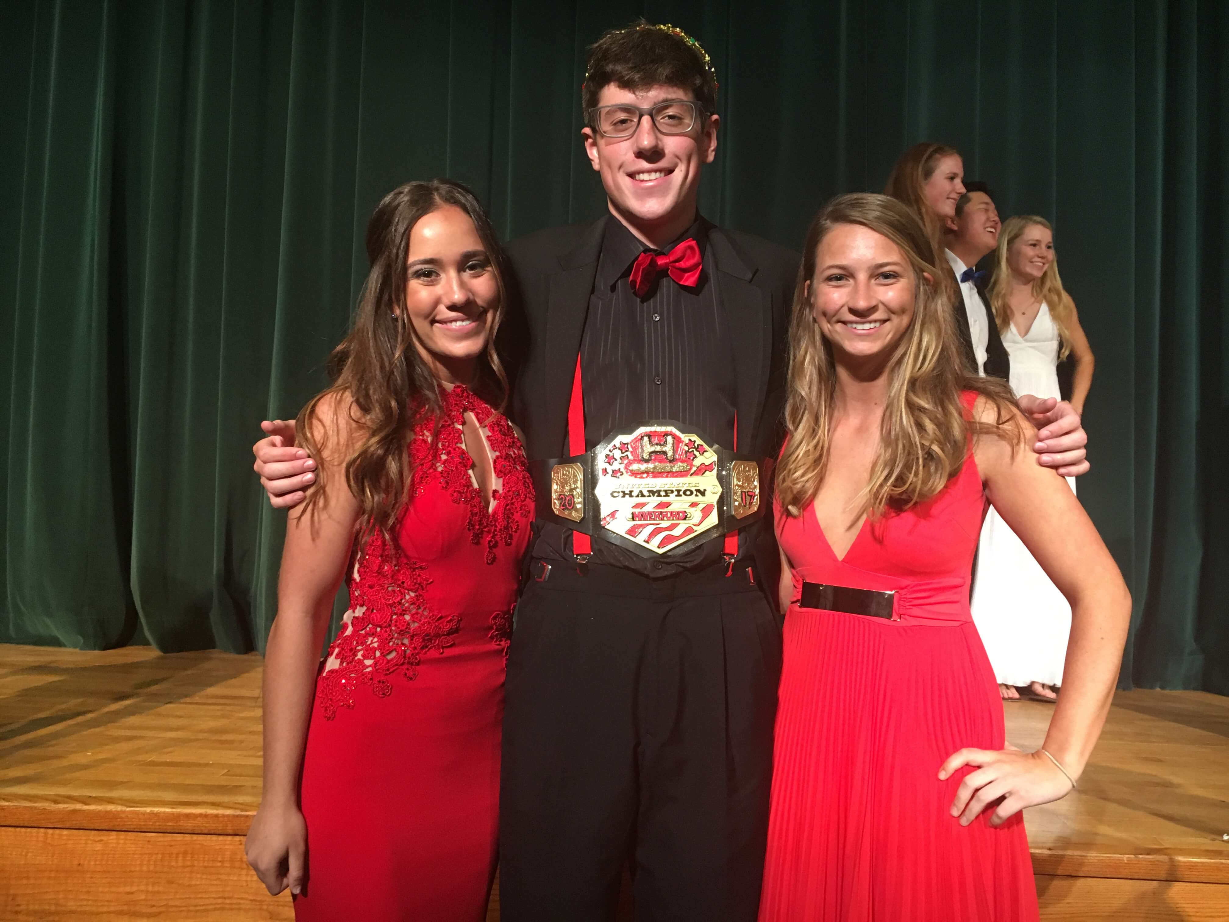 Senior escorts, Gabrielle Gentile and Amira Gallagher, flank Mr. Haverford 2017, Tyler Kimble, in the conclusion of the event.