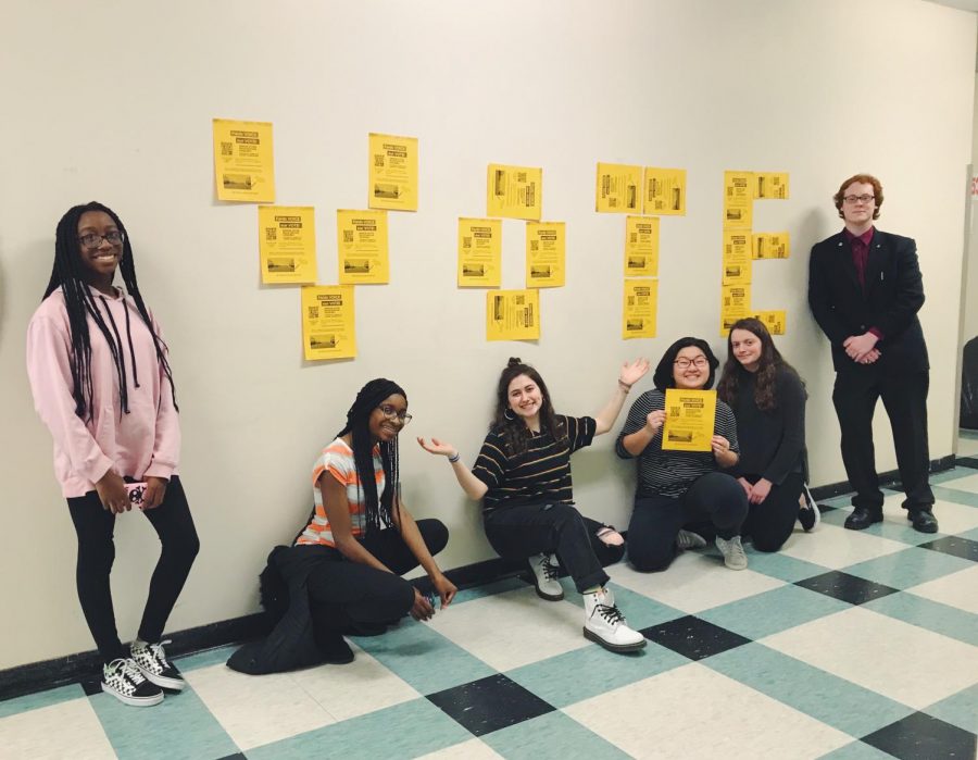 Members of the Young Democrats Club pose in front of their VOTE display. 