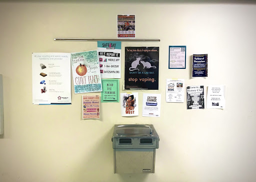 The wall outside of the first floor restrooms displays several of the numerous flyers hung by  school clubs, including No Place For Hate, Future Business Leaders of America, and History Club. 