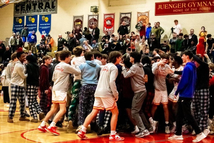 The Haverford student section rushes the court to celebrate with the boys basketball team. 