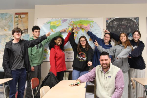 Mr. Host and his AP Euro students point to the subject of their studies.