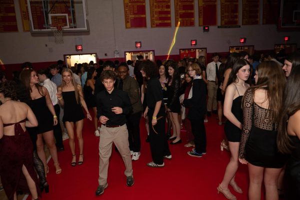 At the Haverford Homecoming Dance, featuring the theme Glow Party, students fill the dance floor, including Ellison Luther, Noah Velis, and Taylor Gleason.