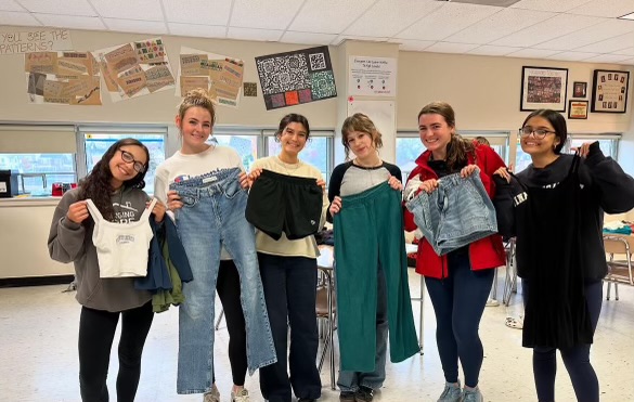 Imara Kay, Sheala O'Neill, Lauren Cascarina, Emerson Simmons, Riona O'Neill, and Neilla Shonasairieva display the clothes they received by participating in Girl Up's Clothing Swap, an effort to reduce fabric waste.