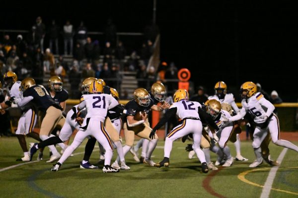 West Chester Rustin runs the ball into Roman Catholic's defense.