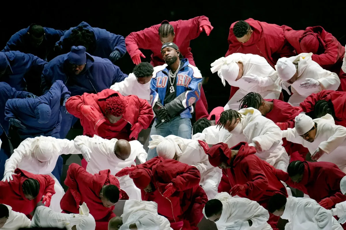 Kendrick Lamar stands among his backup dancers positioned in the American Flag during his halftime performance at Super Bowl LIX. 