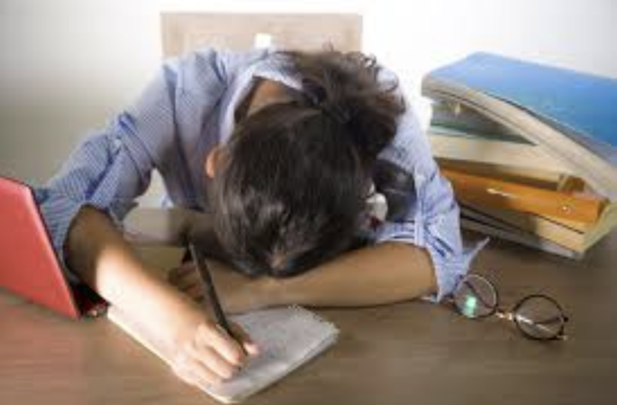 An American student collapses in exhaustion from the pressures of schoolwork.