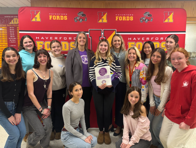 Club members gathered to present the funds to the Executive Director of DAPDC, Michelle Brown (middle left). Also featured is club president Adeline Spitz (middle), DAPDC Managing Attorney Kelley Spitz (middle right), and Club Sponsor Jennifer McNulty-Brown (middle right).
