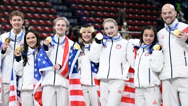 USA Team gold medal winners pictured with their medals left to right: Evan Bates, Madison Chock, Ilia Malinin, Alysa Liu, Amber Glenn, Ellie Kam, Danny O'Shea. Photo credits: NBC