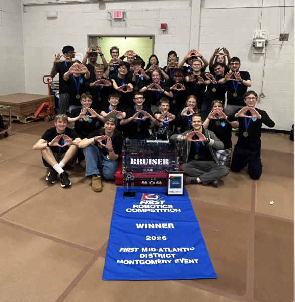 Haverford's robotics team, Roboforce, poses as a team with their winning blue banner.