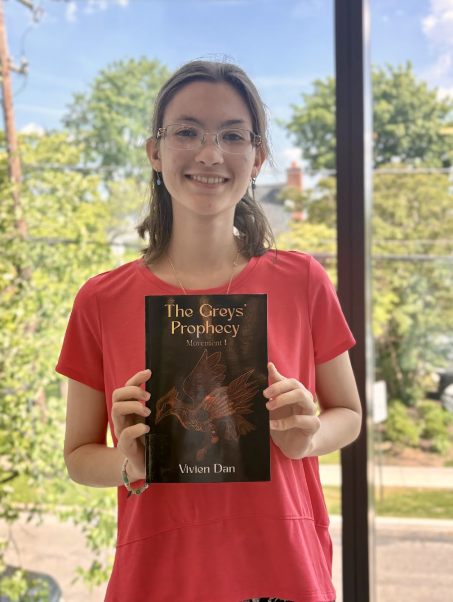 Vivien Dan poses with novel, The Grey’s Prophecy. Photo credits to Christian Schumann.